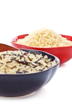 two bowls with rice and wooden spoon