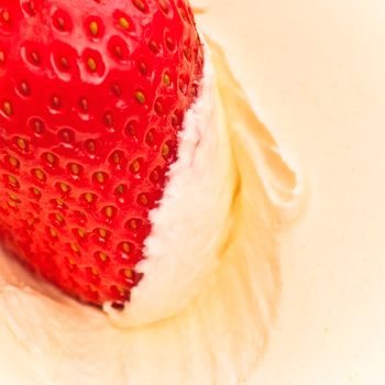 fresh strawberry in sour cream, close up