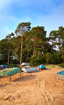 desolate beach with old boats at summer day