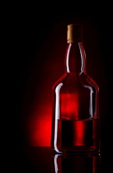 bottle of whiskey on deep red background