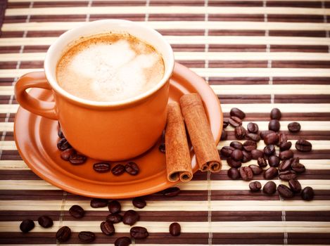 fresh coffee cup and beans on bamboo napkin