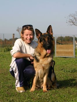 portrait of a  purebred german shepherd and his owner outdoors