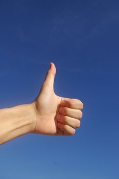 Thumbs up in blue sky