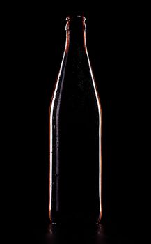 empty beer bottle isolated on black background