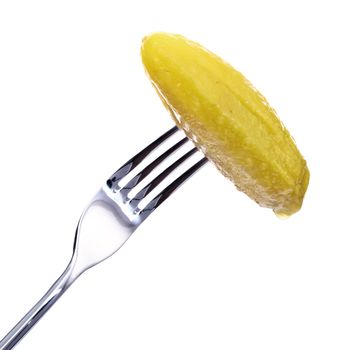 fresh pickle on fork isolated on white background