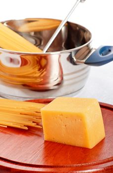 spaghetti, chees and kitchen utensil on table