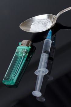 Syringe, spoon, heroin and lighter, concept of addiction