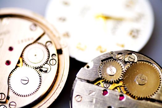 some parts of old metal mechanical clock with gear wheels as retro background