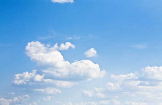 cumulus clouds soaring on the blue sky