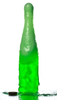 bottle of soda with splashes and foam over white background