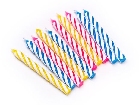 some striped birthday candles on white background