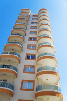 high modern residential building on a background blue sky