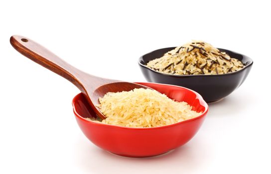 two bowls with rice and wooden spoon