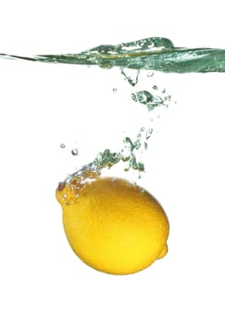 lemon is dropped into water splash isolated on white