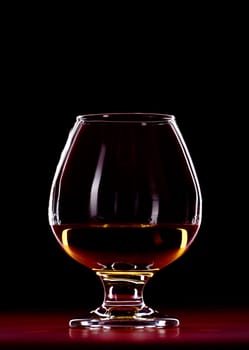 elegant whiskey glass isolated on black background