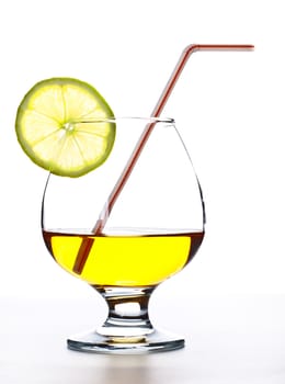 cocktail in glass with slice of lime and straw