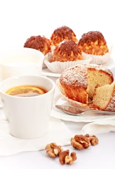 tea with lemon and fancy cakes, still life