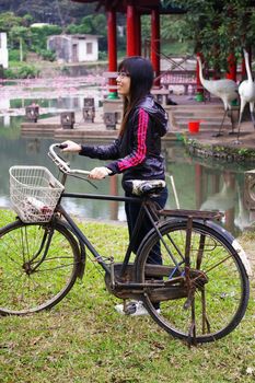 Asian woman riding bicycle with smile