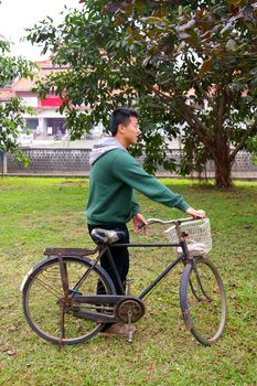 Asian man riding bicycle