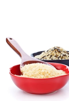 two bowls with rice and wooden spoon