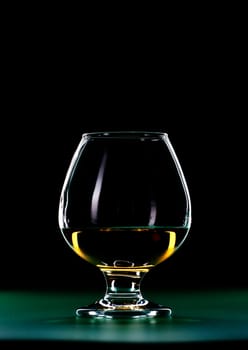 elegant whiskey glass isolated on black background