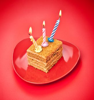 birthday cake with candle on pink background