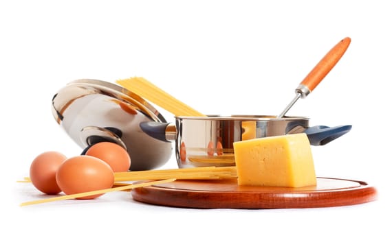 spaghetti, eggs and kitchen utensil on white background