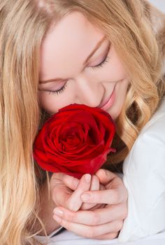 portrait of pretty smiling woman with red rose