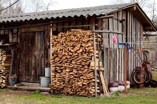 old village barn witn stack of wood