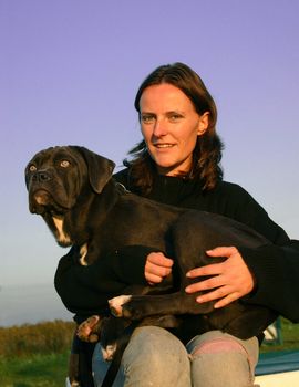 portrait of purebred  italian mastiff and woman in the nature