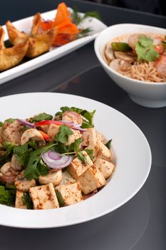Fresh Thai food stir fry with tofu shrimp noodle soup and other appetizers.