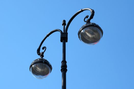 Vintage street lamp on blue sky background