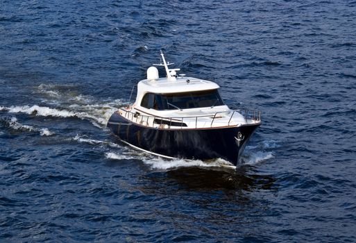 fast black and white motor boat on blue water