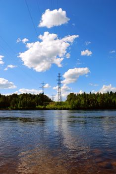 high-voltage line across the river at sunny summer day