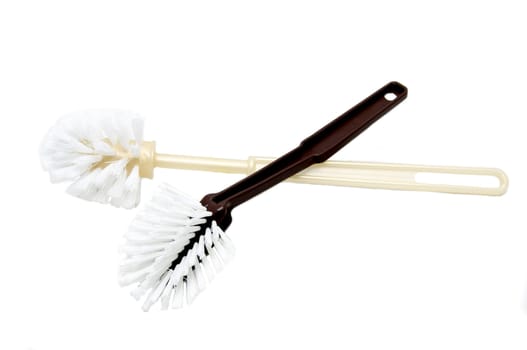 two toilet brushes on a white background
