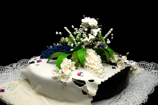 a large chocolate cake decorated with white flowers