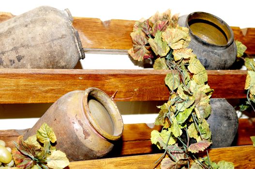 a few old pots on a wooden shelf