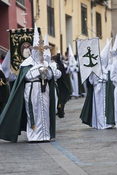 Easter nazarenes in white robe in a typical Spanish procession. 