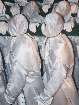 Easter nazarenes in white robe in a typical Spanish procession. 