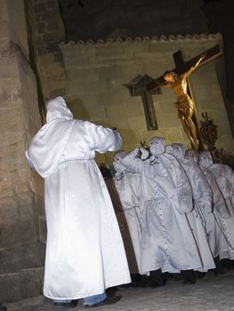 Easter nazarenes in white robe in a typical Spanish procession. 