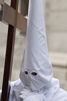 Easter nazarene in white robe in a typical Spanish procession. 