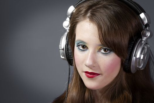 beautiful girl in headphones on a dark grey background