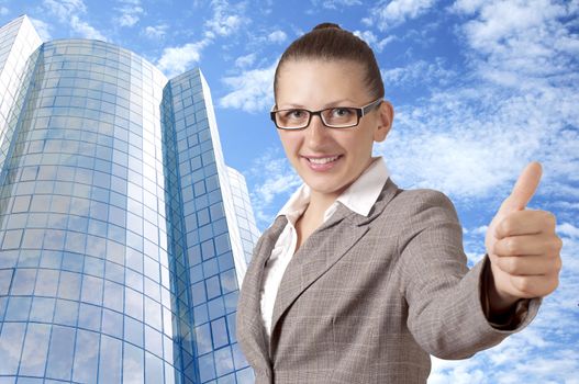 Happy businesswoman showing his thumb up with smile, office building background