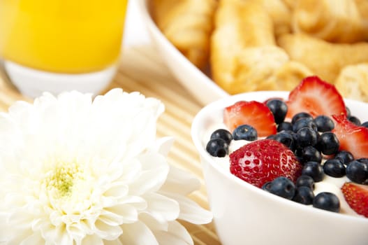 light Breakfast: orange juice, croissants and Berries on a table