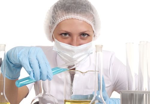 young woman scientist  chemist mixes the liquid in the tubes