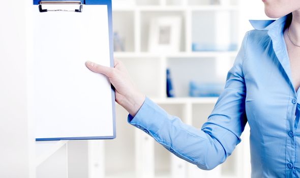 woman puts a tablet with documents in a rack for documents