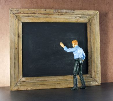 Business person against the blackboard with brown grunge wallpaper