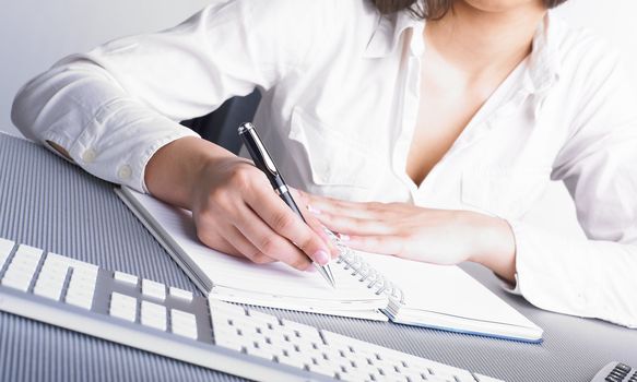 Office Assistant in white writing Schedule