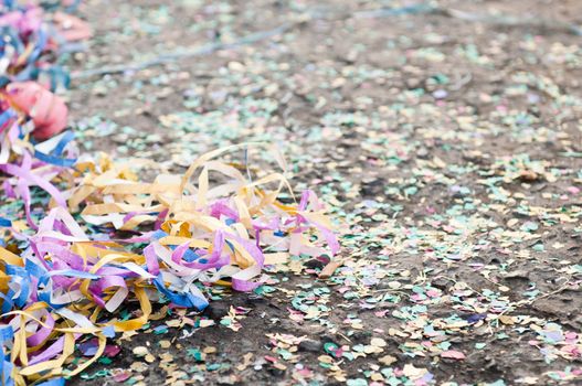 colorful confetti and streamers at the street after Carnival Parade (shallow DOF)