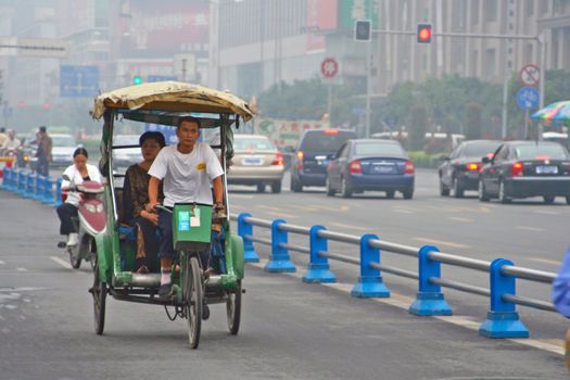 CHENGDU, CHINA - SEPTEMBER 16: Pedicab on the road on September 16, 2006 in Chengdu, Sichuan, China